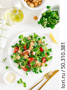 Caesar salad with grilled chicken meat, fresh tomato, croutons, lambs lettuce and parmesan cheese. Healthy lunch. Top view. Стоковое фото, агентство Ingram Publishing / Фотобанк Лори