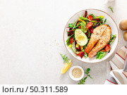 Salmon fish steak grilled, avocado and fresh vegetable salad with tomato, bell pepper and leafy vegetables. Top view. Стоковое фото, агентство Ingram Publishing / Фотобанк Лори