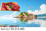 Flag and seagulls and Sveti Stefan island in Montenegro. Стоковое фото, агентство Ingram Publishing / Фотобанк Лори