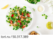 Caesar salad with grilled chicken meat, fresh tomato, croutons, lambs lettuce and parmesan cheese. Healthy lunch. Top view. Стоковое фото, агентство Ingram Publishing / Фотобанк Лори