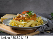 Vegetarian lentil Bolognese sauce penne pasta on a dark background. Healthy eating concept. Стоковое фото, агентство Ingram Publishing / Фотобанк Лори