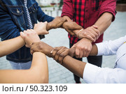 anonymous multiracial people stacking hands. Стоковое фото, агентство Ingram Publishing / Фотобанк Лори