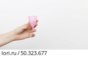 close up hand holding menstrual cup. Стоковое фото, агентство Ingram Publishing / Фотобанк Лори