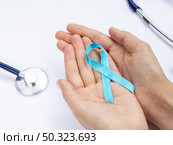 close up hands holding blue ribbon with stethoscope. Стоковое фото, агентство Ingram Publishing / Фотобанк Лори