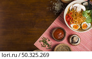 ramen noodles asian style with sauces wooden table . Resolution and high quality beautiful photo. ramen noodles asian style with sauces wooden table . High quality and resolution beautiful photo concept. Стоковое фото, агентство Ingram Publishing / Фотобанк Лори