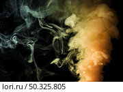 yellow dense fume smoke abstract black background. Resolution and high quality beautiful photo. yellow dense fume smoke abstract black background. High quality and resolution beautiful photo concept. Стоковое фото, агентство Ingram Publishing / Фотобанк Лори