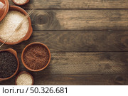 overhead view red brown white rice bowls wooden background. Resolution and high quality beautiful photo. overhead view red brown white rice bowls wooden background. High quality beautiful photo concept. Стоковое фото, агентство Ingram Publishing / Фотобанк Лори