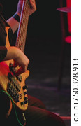 Musician playing bass guitar on stage. Close-up of five-stringed instrument and professional playing on it. Live concert. Стоковое видео, видеограф Воловодов Владимир / Фотобанк Лори