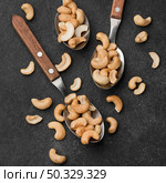 close up spoons filled with healthy raw cashew nuts. High resolution photo. close up spoons filled with healthy raw cashew nuts. High quality photo. Стоковое фото, агентство Ingram Publishing / Фотобанк Лори