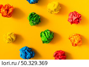 colorful crumpled paper ball yellow background. High resolution photo. colorful crumpled paper ball yellow background. High quality photo. Стоковое фото, агентство Ingram Publishing / Фотобанк Лори