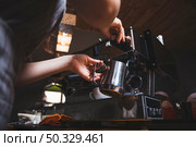 female barista prepares espresso from coffee machine caf. High resolution photo. female barista prepares espresso from coffee machine caf. High quality photo. Стоковое фото, агентство Ingram Publishing / Фотобанк Лори