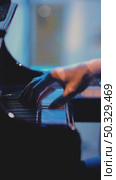 A pianist with one hand playing gentle classical music on a grand piano in slow motion. Close-up of piano keys in dark colors. Стоковое видео, видеограф Воловодов Владимир / Фотобанк Лори