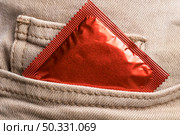jeans pocket wrapped condom. High resolution photo. jeans pocket wrapped condom. High quality photo. Стоковое фото, агентство Ingram Publishing / Фотобанк Лори