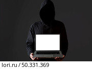 front view male hacker holding laptop. High resolution photo. front view male hacker holding laptop. High quality photo. Стоковое фото, агентство Ingram Publishing / Фотобанк Лори
