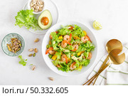 Grilled shrimp salad with avocado, mango, lettuce and pistachios, dressed with lime. Healthy food. Ketogenic diet. Top view. Стоковое фото, агентство Ingram Publishing / Фотобанк Лори
