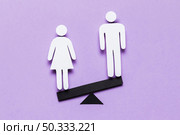 cartoon woman standing lower side seesaw. Стоковое фото, агентство Ingram Publishing / Фотобанк Лори