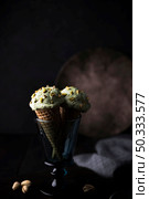 front view pistachio icecream with nuts. Стоковое фото, агентство Ingram Publishing / Фотобанк Лори