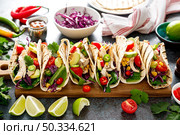Chicken tacos with grilled meat, avocado, fresh vegetable salad and sauce salsa. Стоковое фото, агентство Ingram Publishing / Фотобанк Лори