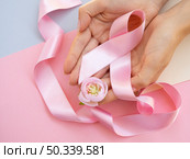 OLYMPUS DIGITAL CAMERA. close up person with pink ribbon top view. Стоковое фото, агентство Ingram Publishing / Фотобанк Лори