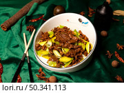 Delicious Sauteed Beef With Scallions Presented on a Green Velvet Tablecloth. Стоковое фото, фотограф Aleksandr Golubev / Фотобанк Лори