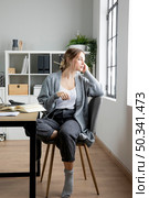full shot woman sitting chair. Стоковое фото, агентство Ingram Publishing / Фотобанк Лори