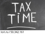 tax time written black backboard with chalk. Стоковое фото, агентство Ingram Publishing / Фотобанк Лори