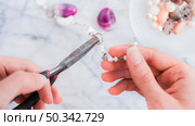 close up female s hand fixing metallic ring with pliers. Стоковое фото, агентство Ingram Publishing / Фотобанк Лори