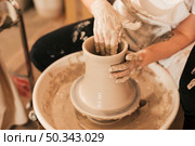 female potter s hand making ceramic pot with clay pottery wheel. Стоковое фото, агентство Ingram Publishing / Фотобанк Лори