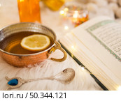 OLYMPUS DIGITAL CAMERA. close up tea opened quran. Редакционное фото, агентство Ingram Publishing / Фотобанк Лори