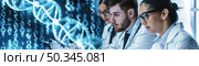 Team of three researchers studies DNA sequences on a digital screen in a lab setting. Стоковое AI-изображение, AI-художник Данила Большаков / Фотобанк Лори