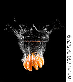 mandarine plunging into water. Стоковое фото, агентство Ingram Publishing / Фотобанк Лори