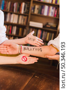 stop bullying slogan children s arms. Стоковое фото, агентство Ingram Publishing / Фотобанк Лори