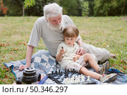 front view grandson sitting with grandpa. Стоковое фото, агентство Ingram Publishing / Фотобанк Лори