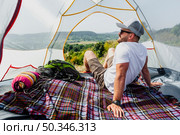 front view man tent enjoying view. Стоковое фото, агентство Ingram Publishing / Фотобанк Лори