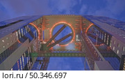 Osaka, Japan - Sep 25 2024, 4k, panoramic view from bottom to top of the illuminating ring between the two towers of Umeda Sky Building, in the evening with cloudy sky, Osaka, Japan. Стоковое видео, видеограф Сергей Богомяко / Фотобанк Лори