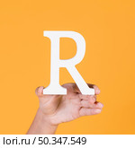 deaf woman s hand holding r alphabet. Стоковое фото, агентство Ingram Publishing / Фотобанк Лори