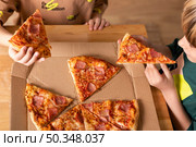 kids eating pizzas together. Стоковое фото, агентство Ingram Publishing / Фотобанк Лори
