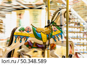nostalgic horse detail carousel spinning with light blurs night. Стоковое фото, агентство Ingram Publishing / Фотобанк Лори