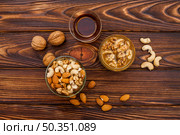 cup tea near set fresh nuts saucers. Стоковое фото, агентство Ingram Publishing / Фотобанк Лори