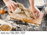 person kneading dough with flour chopping board. Стоковое фото, агентство Ingram Publishing / Фотобанк Лори