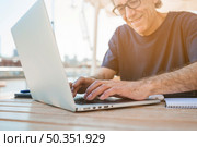 smiling senior man using laptop outdoor caf. Стоковое фото, агентство Ingram Publishing / Фотобанк Лори