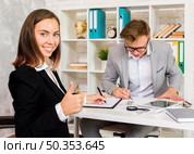 young woman appreciates work architect. Стоковое фото, агентство Ingram Publishing / Фотобанк Лори