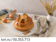Fogaca on kitchen countertop with eggs and cinammon sticks. Traditional cake from Santa Maria da Feira, Portugal. Стоковое фото, агентство Ingram Publishing / Фотобанк Лори