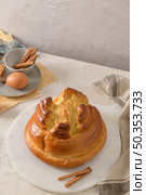 Fogaca on kitchen countertop with eggs and cinammon sticks. Traditional cake from Santa Maria da Feira, Portugal. Стоковое фото, агентство Ingram Publishing / Фотобанк Лори