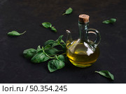 bottled olive oil with spinach around it. Стоковое фото, агентство Ingram Publishing / Фотобанк Лори