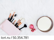 makeup brushes bag with pink compact powder round mirror fur backdrop. Стоковое фото, агентство Ingram Publishing / Фотобанк Лори