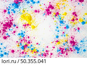 splatter yellow pink blue holi color powder white background. Стоковое фото, агентство Ingram Publishing / Фотобанк Лори