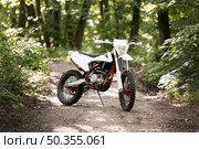 stylish motorbike parked forrest. Стоковое фото, агентство Ingram Publishing / Фотобанк Лори