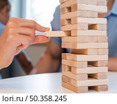 close up family playing jenga together. Стоковое фото, агентство Ingram Publishing / Фотобанк Лори