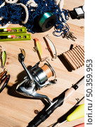 fishing net fishing reel lures fishing rod wooden backdrop. Стоковое фото, агентство Ingram Publishing / Фотобанк Лори